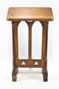A Victorian oak lectern, with pierced Gothic panel, on hinged feet, 118cm high, 69cm wide,