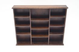 A mahogany hanging wall shelf divided with pigeon holes, 46cm high, 56cm wide,