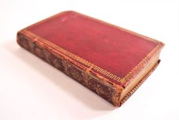 A red Morocco bound copy of The Book of Common Prayer 1785