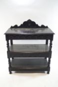 A Victorian oak three tier buffet of rectangular form with carved shaped cresting rail