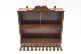 A 19th century oak two tier hanging wall shelf with shaped crest,