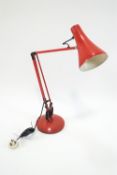 A red anglepoise lamp,