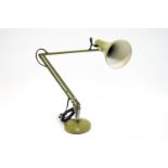 A green anglepoise lamp,