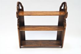A 19th century mahogany three tier wall shelf, with pierced supports, 63cm high, 60cm wide,