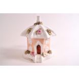 A 19th century porcelain smoke house pastille burner in the form of a hexagonal cottage,