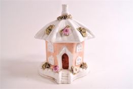 A 19th century porcelain smoke house pastille burner in the form of a hexagonal cottage,