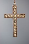 A yellow and white metal cross pendant set with graduated old cut diamonds.,