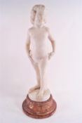 An Art Deco white marble carving of a girl, signed (?) Schmid on a brown marble socle,