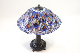 A Tiffany glass style table lamp with a peacock shade, 66cm high,