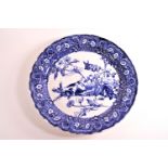 A Doulton series blue printed charger, decorated with a dog chasing a rabbit, in a floral border,