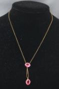 A yellow metal centrepiece drop pendant set with intense pink paste stones.