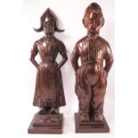 A pair of bronzed metal Art Deco fireside companion sets in the form of a Dutch boy and girl