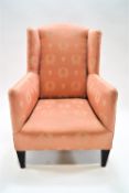 A child's wing back armchair, on square tapering mahogany legs, 79cm high, 48cm wide,