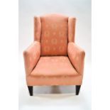 A child's wing back armchair, on square tapering mahogany legs, 79cm high, 48cm wide,