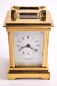 A brass cased miniature carriage clock (with key), by David Peterson,