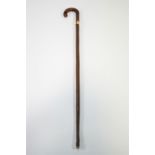 A walking stick with gold band and a walking cane with turned ivory handle,
