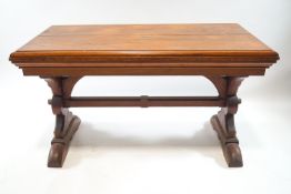 A 19th century rectangular pine table, on Gothic supports and stretcher, 73cm high, 129cm wide,