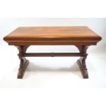 A 19th century rectangular pine table, on Gothic supports and stretcher, 73cm high, 129cm wide,