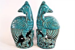 A pair of early 20th century Chinese stoneware Ho Ho birds, with translucent turquoise glaze,