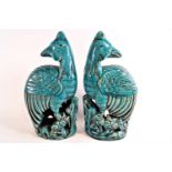 A pair of early 20th century Chinese stoneware Ho Ho birds, with translucent turquoise glaze,