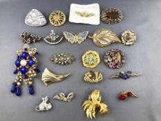 A collection of twenty brooches of various designs. Finished in base metals and paste stones.