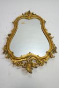 An 18th century and later wall mirror with carved wood and gilded frame,