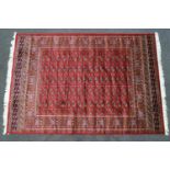 A machine woven Keishan style carpet with eleven rows of medallions