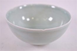 A Studio porcelain bowl, of Chinese plain celadon form with incised decoration and lobed ridged rim,