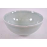 A Studio porcelain bowl, of Chinese plain celadon form with incised decoration and lobed ridged rim,