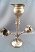 A loaded silver three branch epergne with a wavy edged baluster vase