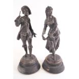 A pair of Spelter figures on wooden bases being a dancing girl and a boy with a miniature bugle,