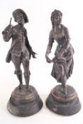 A pair of Spelter figures on wooden bases being a dancing girl and a boy with a miniature bugle,