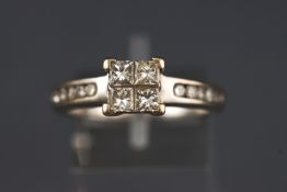 A white metal dress ring set with four princess cut diamonds