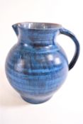 A Bert Middleton of Looe blue glazed earthenware jug,