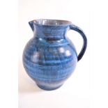 A Bert Middleton of Looe blue glazed earthenware jug,