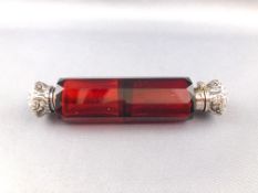 A panel cut ruby glass double double scent bottle with white metal hinged and screw off tops,