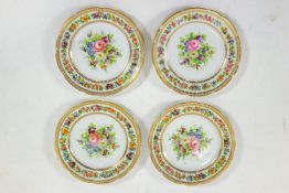 A set of four German porcelain plates, painted in coloured enamels and gilt, 22cm diameter,