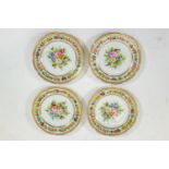 A set of four German porcelain plates, painted in coloured enamels and gilt, 22cm diameter,