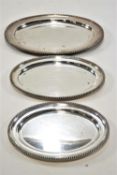 Three silver plated graduated oval platters with gadrooned edges,