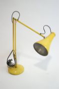 A yellow anglepoise lamp,