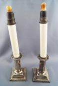 A pair of loaded silver candlesticks with bead edge decoration,