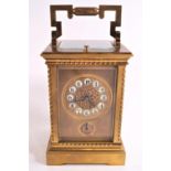 A 19th century gilt and four glass carriage clock with enamel Arabic numerals above an alarm dial