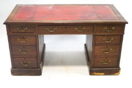 A nineteenth century mahogany pedestal desk with red leather inset top above three freeze drawers