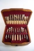 An oak canteen of silver plated cutlery for eight settings with bone handled knives,