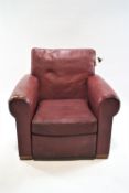 A red leather armchair with loose cushion, on block feet, 83cm high,