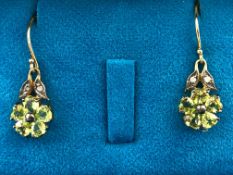 A yellow and white metal pair of drop earrings,