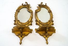 A pair of nineteenth century gilt framed Rococo girandoles,