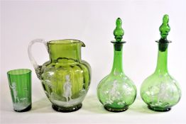 A pair of Mary Gregory style green glass decanters and stoppers, 22cm high,