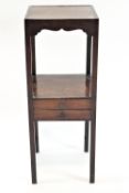 A George III and later mahogany two tier wash stand with two freeze drawers on square legs,