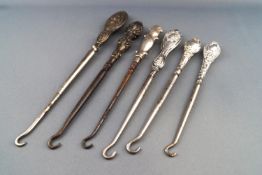A pair of silver button hooks with Rococo style handles, Chester 1906,